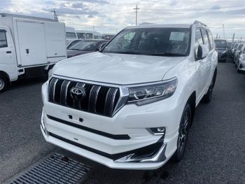 2022 Toyota Prado TXL in white, showcasing luxury SUV design at a car dealership in Bangladesh