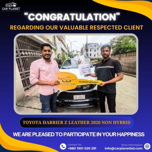 Two men holding a large key plaque in front of a Toyota Harrier Z 2020, celebrating a car purchase from Car Planet.